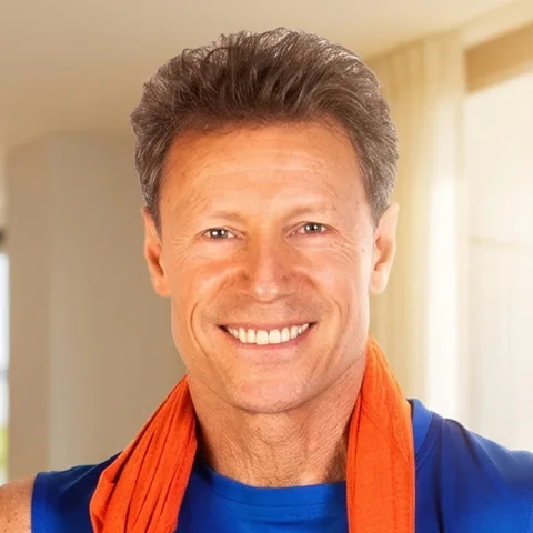 Jaime Brenkus, smiling, a towel around his neck
